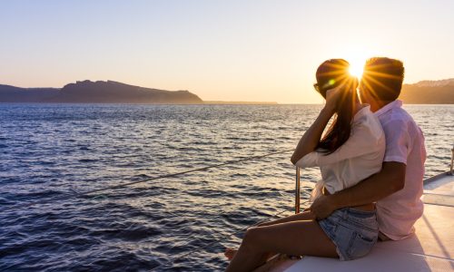 Romantic couple on yacht at sunset in Greece